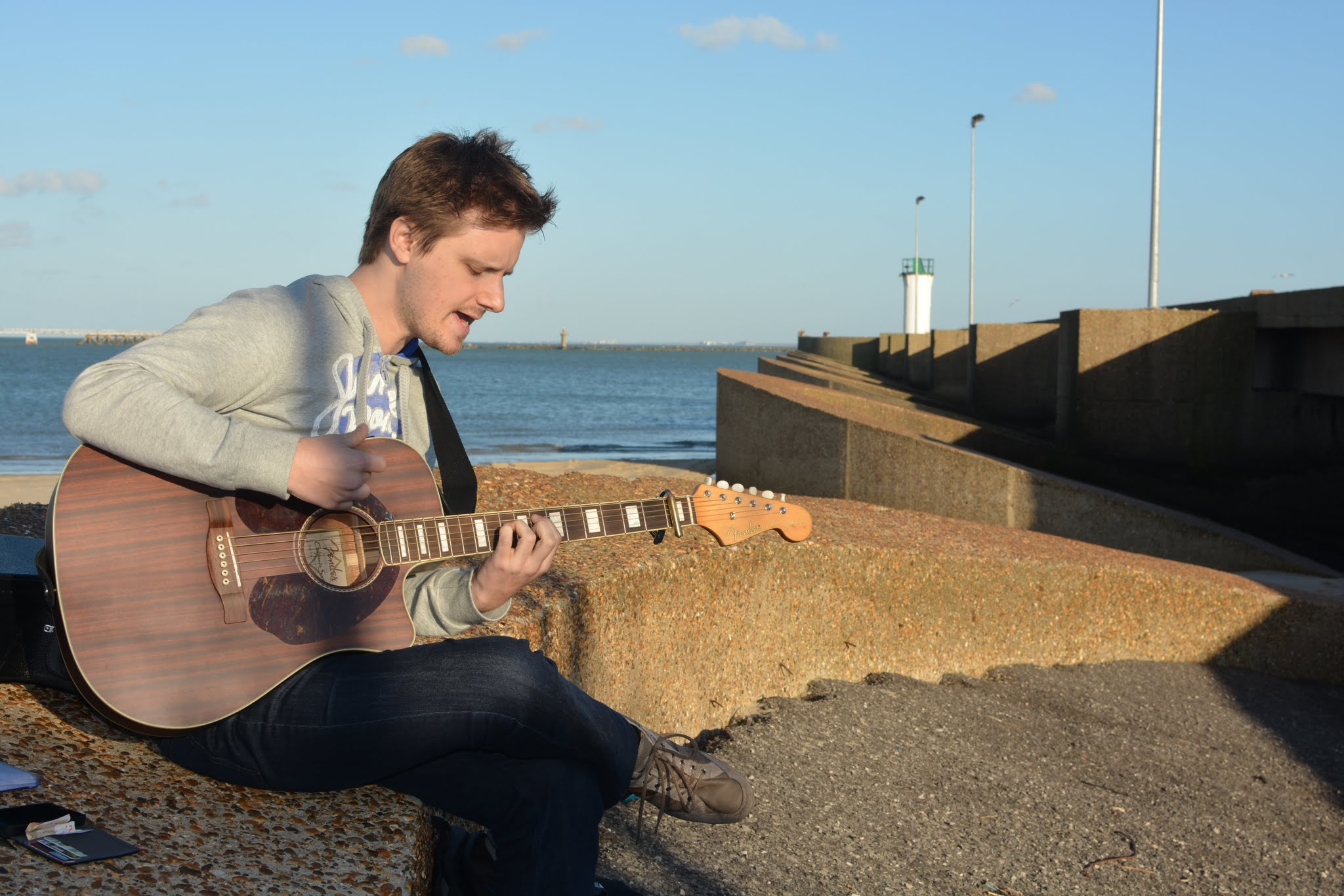 Frans playing guitar by the sea